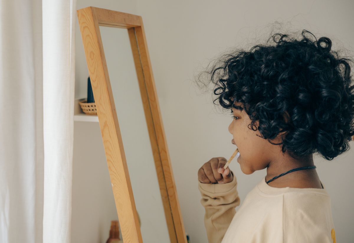 A child brushing their teeth to help prevent baby tooth cavities