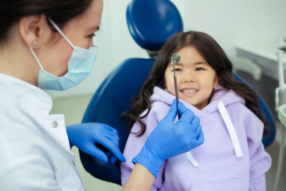 A pediatric dental examination and X-ray review before deciding on a baby tooth extraction